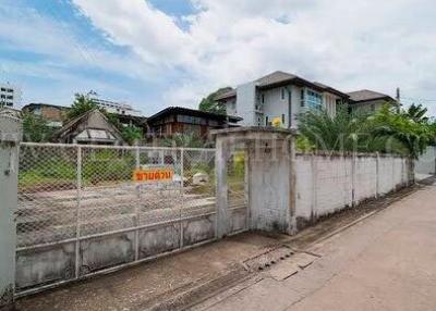 Exterior view of a fenced property with a clear sky