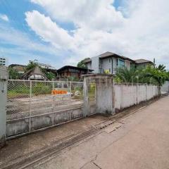 Exterior view of a fenced property with a clear sky