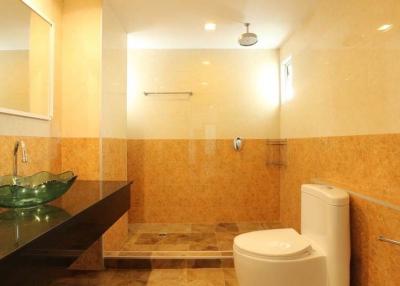 Modern bathroom interior with glass sink and marble tiles