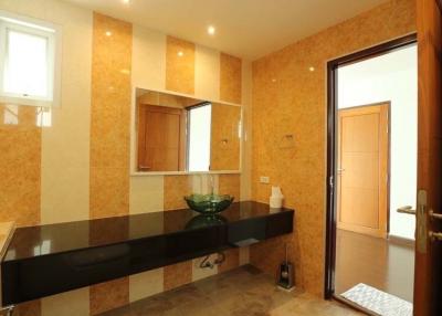 Contemporary bathroom with cork tiles and dark countertop