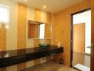 Contemporary bathroom with cork tiles and dark countertop