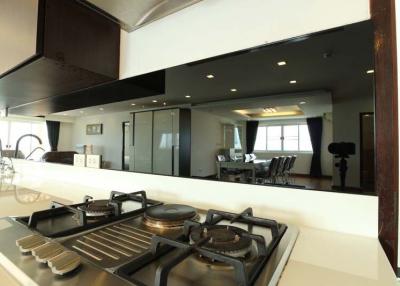 Modern kitchen with view into spacious living and dining area