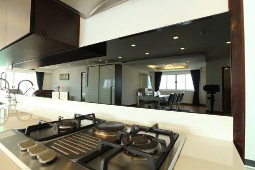 Modern kitchen with view into spacious living and dining area