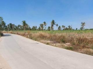 View of a vacant land for sale with a clear sky and a surrounding area of greenery