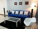 Cozy and modern living room with a comfortable blue sofa and stylish décor