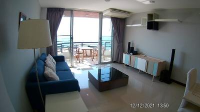 Bright living room with sea view, modern furniture, and balcony access