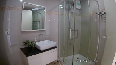 Modern bathroom interior with glass shower and white basin