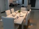 Modern dining area with stylish table setting and open concept layout