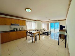 Spacious open-plan kitchen and living room with modern furniture and ample natural light