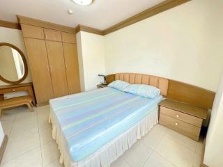 Spacious bedroom with large bed and built-in wardrobe
