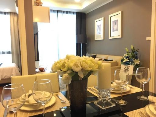 Elegantly decorated living room with dining area and a glimpse of the bedroom