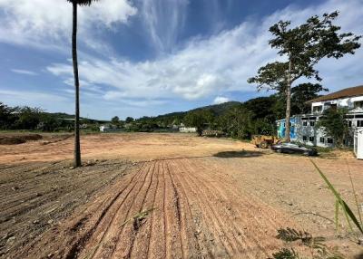 Expansive empty land ready for construction with clear blue sky