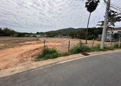 Empty residential lot under a cloudy sky