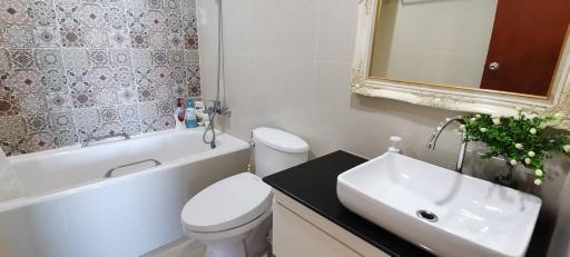 Modern bathroom with bathtub and ornate tiles