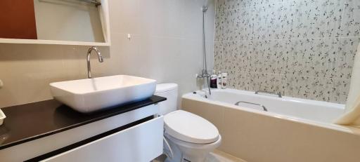 Modern bathroom with floral wallpaper and sleek fixtures