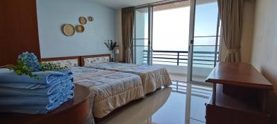 Spacious bedroom with ocean view and balcony access