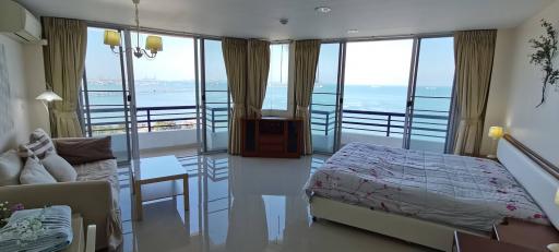 Studio apartment bedroom with ocean view through large windows