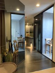 Modern interior design of a hallway with reflective surfaces and glass doors