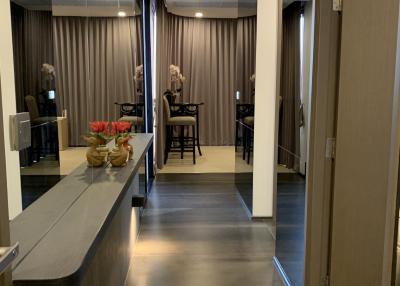 Modern hallway interior leading to a dining area with decorative elements
