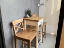 Compact dining space with minimalist wooden table and chairs
