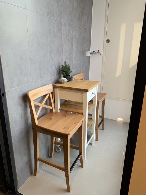 Compact dining space with minimalist wooden table and chairs