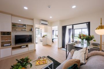 Modern open-plan living room with dining area and kitchen in the background