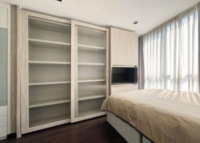 Modern bedroom with large bed and built-in wardrobe