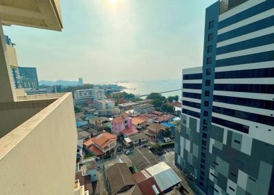 Panoramic view from a high-rise apartment showing cityscape and waterfront