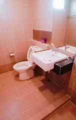 Compact bathroom with tiled walls and flooring