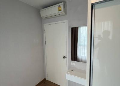 Compact bedroom with air conditioning and wooden flooring