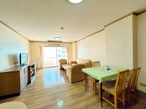 Spacious living room with dining area and natural lighting