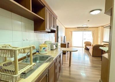 Spacious kitchen with wooden cabinets and tiled flooring