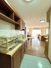 Spacious kitchen with wooden cabinets and tiled flooring