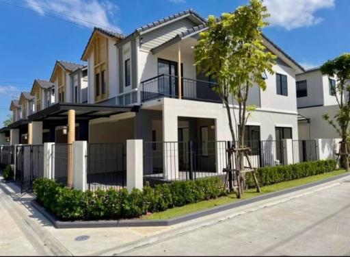 Modern two-story house with balcony and garden