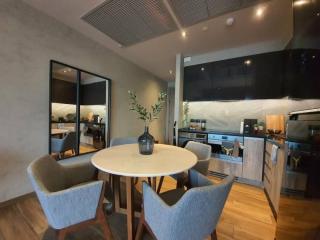 Modern kitchen with adjacent dining area in an open-plan living space