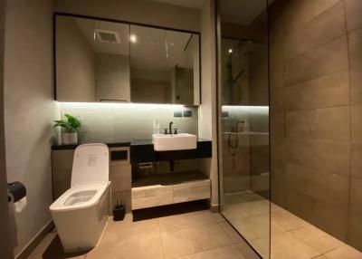 Modern bathroom with glass shower enclosure and LED lighting