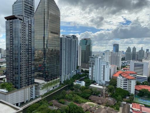 Panoramic view of a bustling city with skyscrapers and residential buildings under a cloudy sky