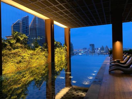 Modern outdoor infinity pool overlooking the city skyline