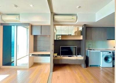 Modern apartment interior with open plan living space including kitchen and entertainment area