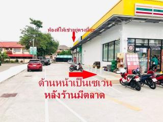 Convenience store front with parking space and vehicles