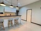 Modern kitchen with bar stools and pendant lighting