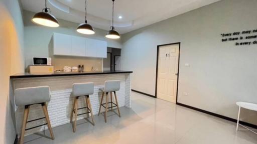 Modern kitchen with bar stools and pendant lighting