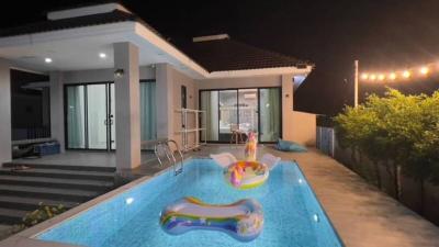 Modern house exterior with swimming pool at night