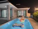 Modern house exterior with swimming pool at night