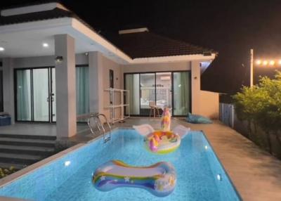 Modern house exterior with swimming pool at night