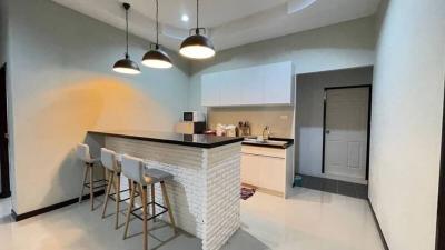 Modern kitchen with bar stools and pendant lighting