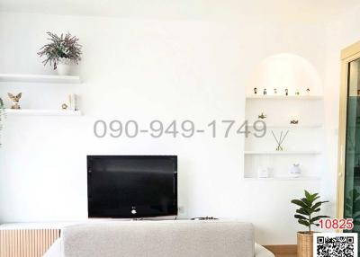 Modern and bright living room with minimalistic decor and large flat screen TV