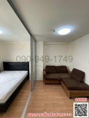 Compact bedroom with bed and sofa, mirrored closet doors