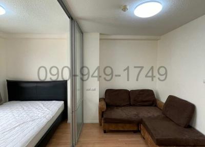 Compact bedroom with bed and sofa, mirrored closet doors