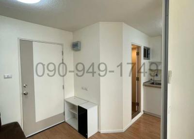 Compact entryway with white walls and tiled flooring